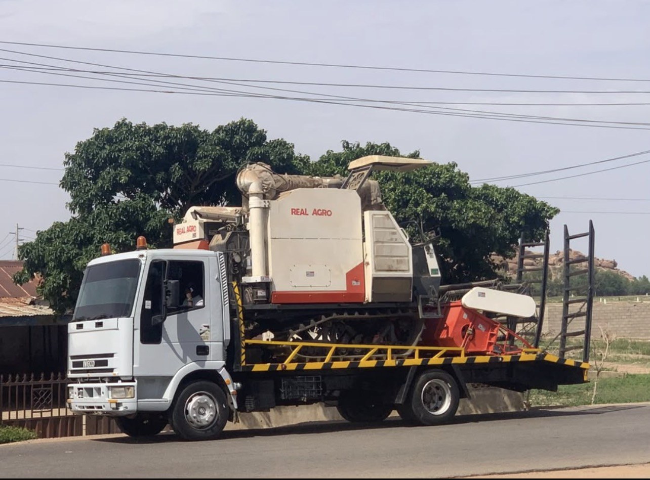 Real Agro combine harvester being transported to a farm